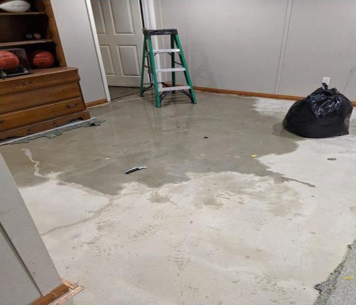 water pooling of the basement concrete floor of a home