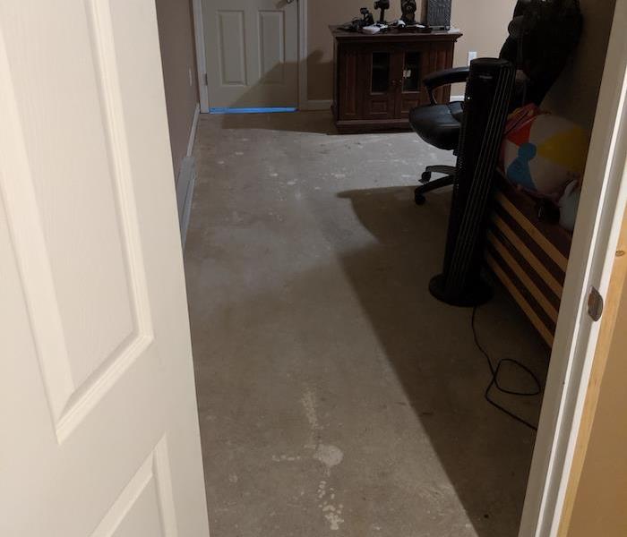 Hallway with flooring removed and bare subfloor showing
