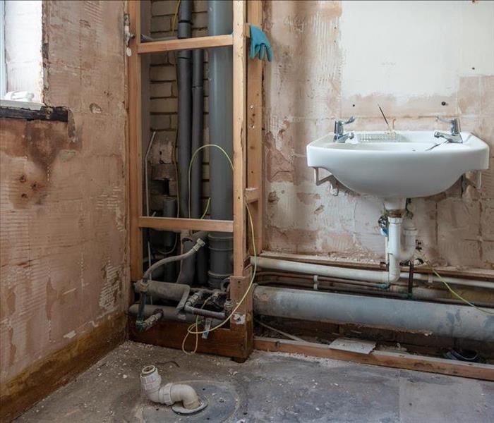 A bathroom stripped bare as it is being refurbished and modernized
