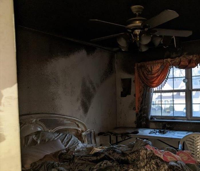 fire damaged bedroom. smoke and soot on walls