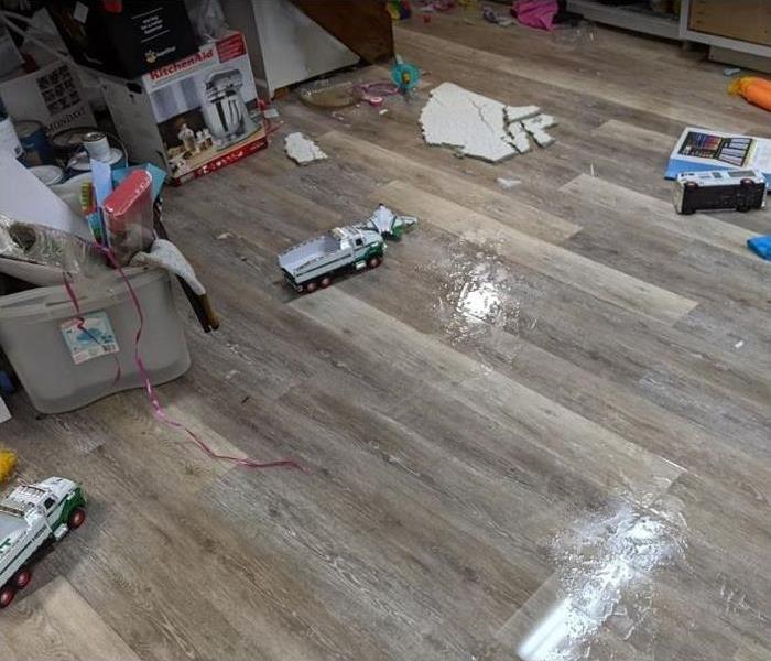 water on floor; personal belongings scattered on floor