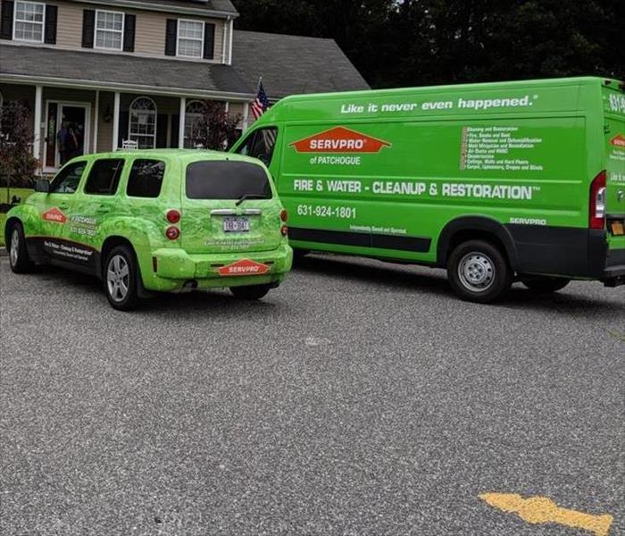 two servpro vehicles parked at house