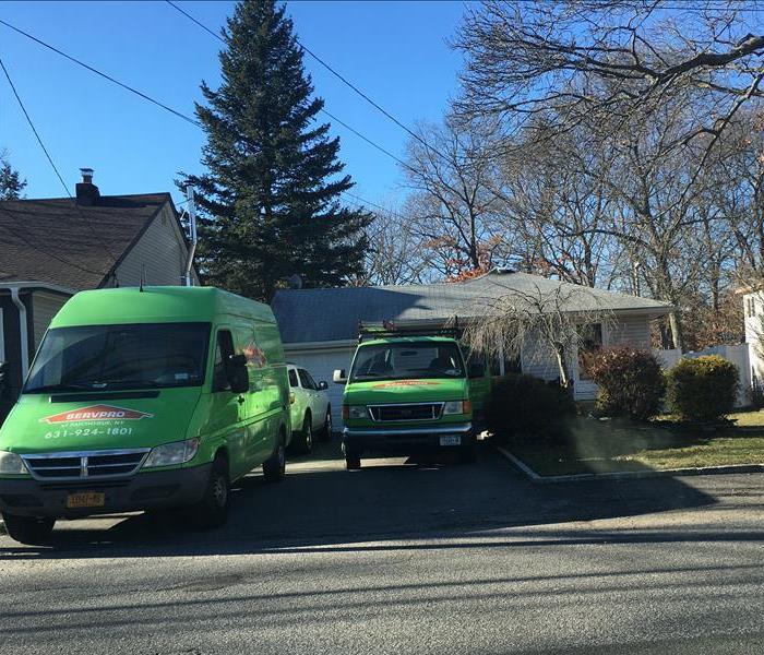 two servpro vehicles at a house