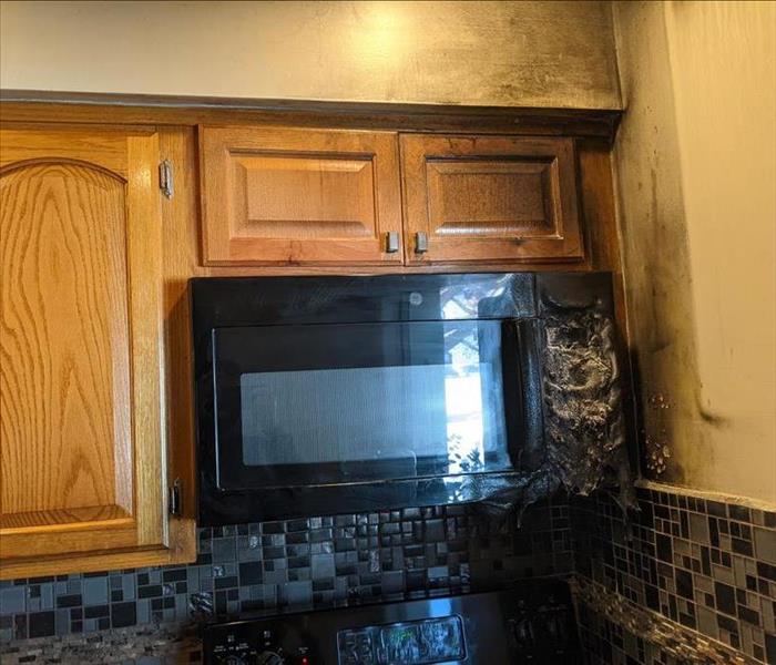 Cabinets and microwave melted and burned from fire damage