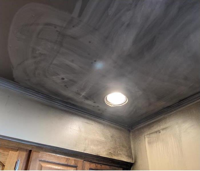 ceiling in a kitchen covered in soot damage
